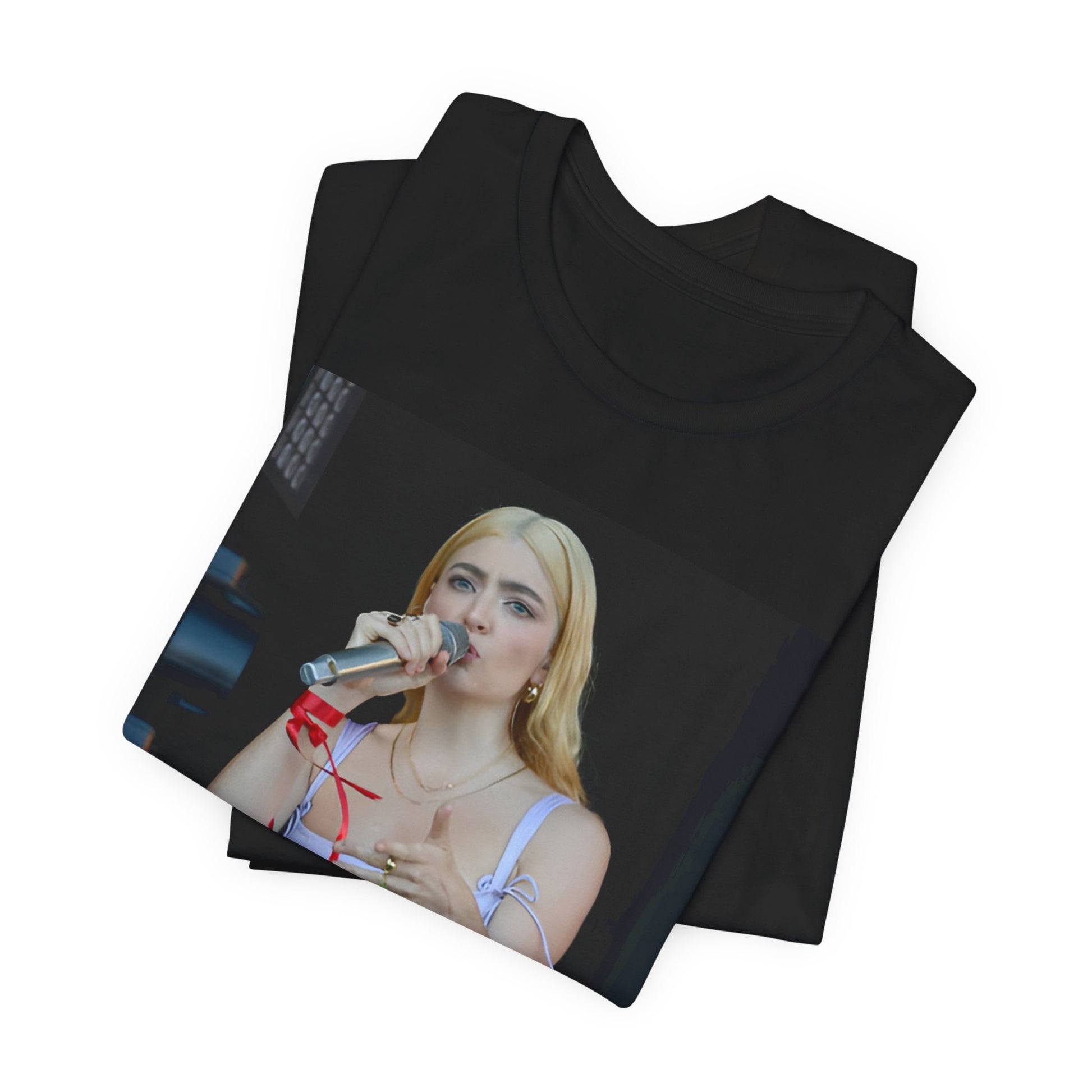 A black graphic t-shirt featuring a graphic or photo of Lorde performing on stage in a cool alternative music style.