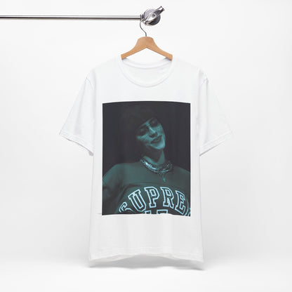 A powerful, close-up portrait of Billie Eilish with a direct and intense stare, printed on a graphic t-shirt.