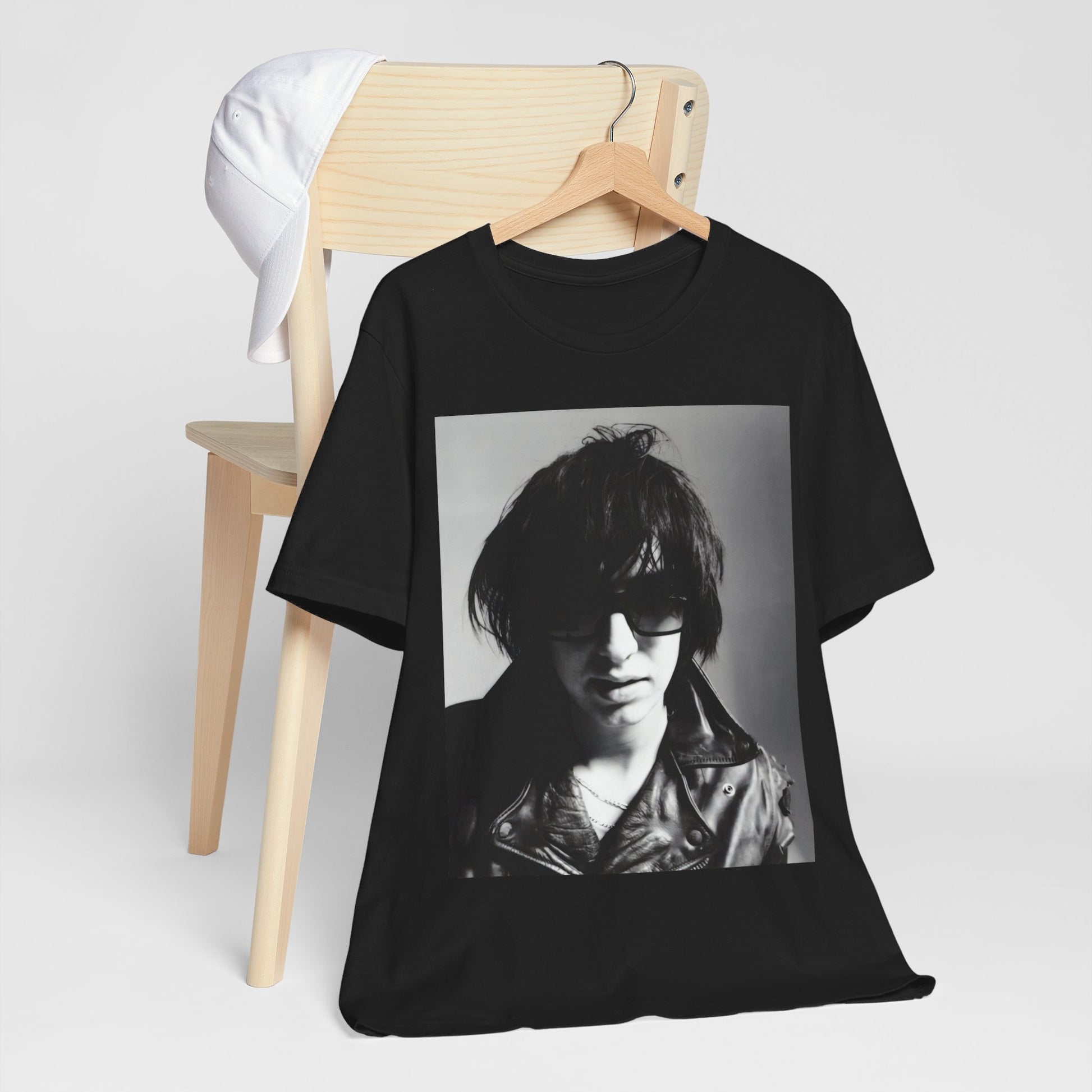 A black graphic t-shirt featuring a graphic related to The Strokes' 'Reptilia' song or era.