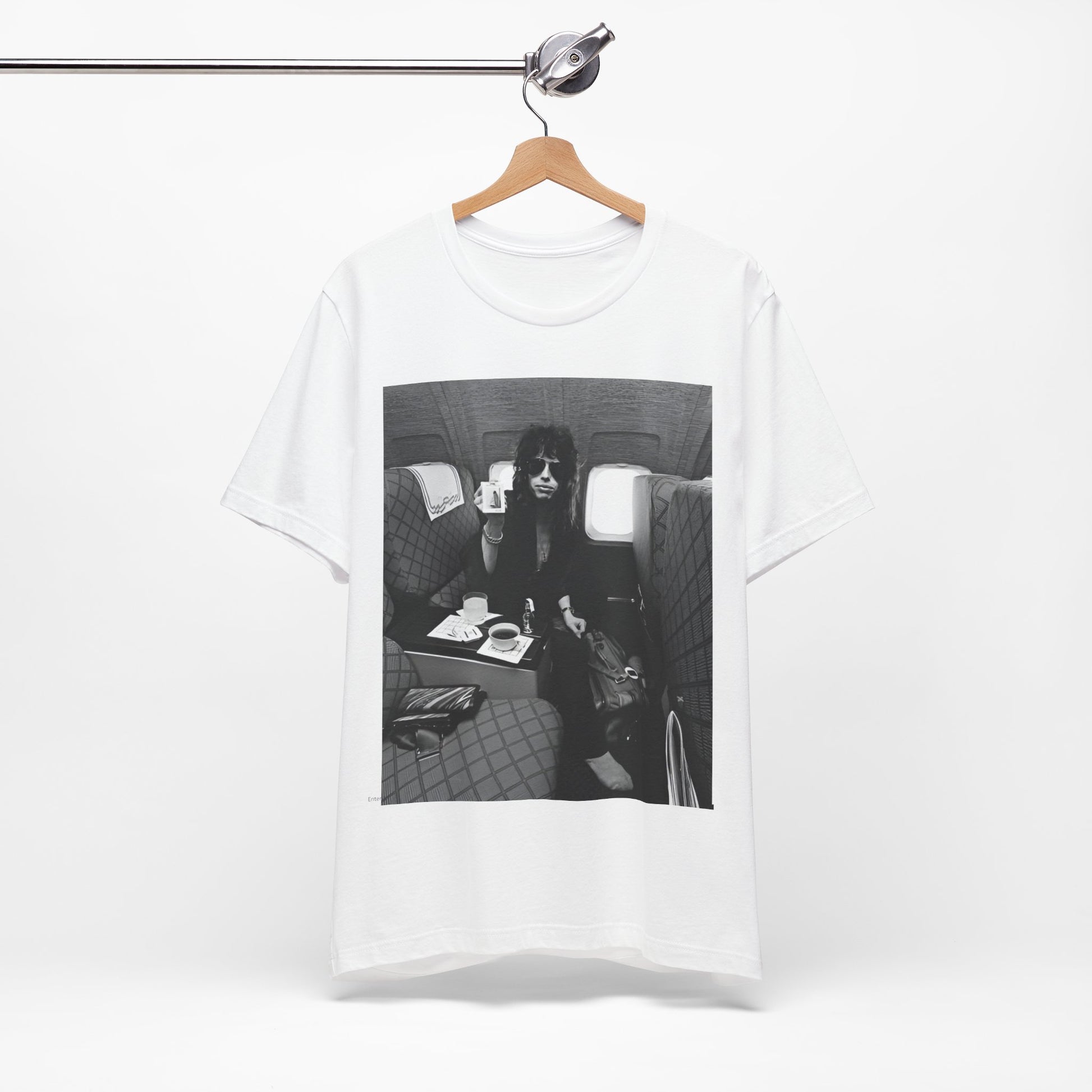 A black graphic t-shirt featuring a vintage 70s-style illustration of an airplane with Aerosmith branding, representing their tour plane from that era.