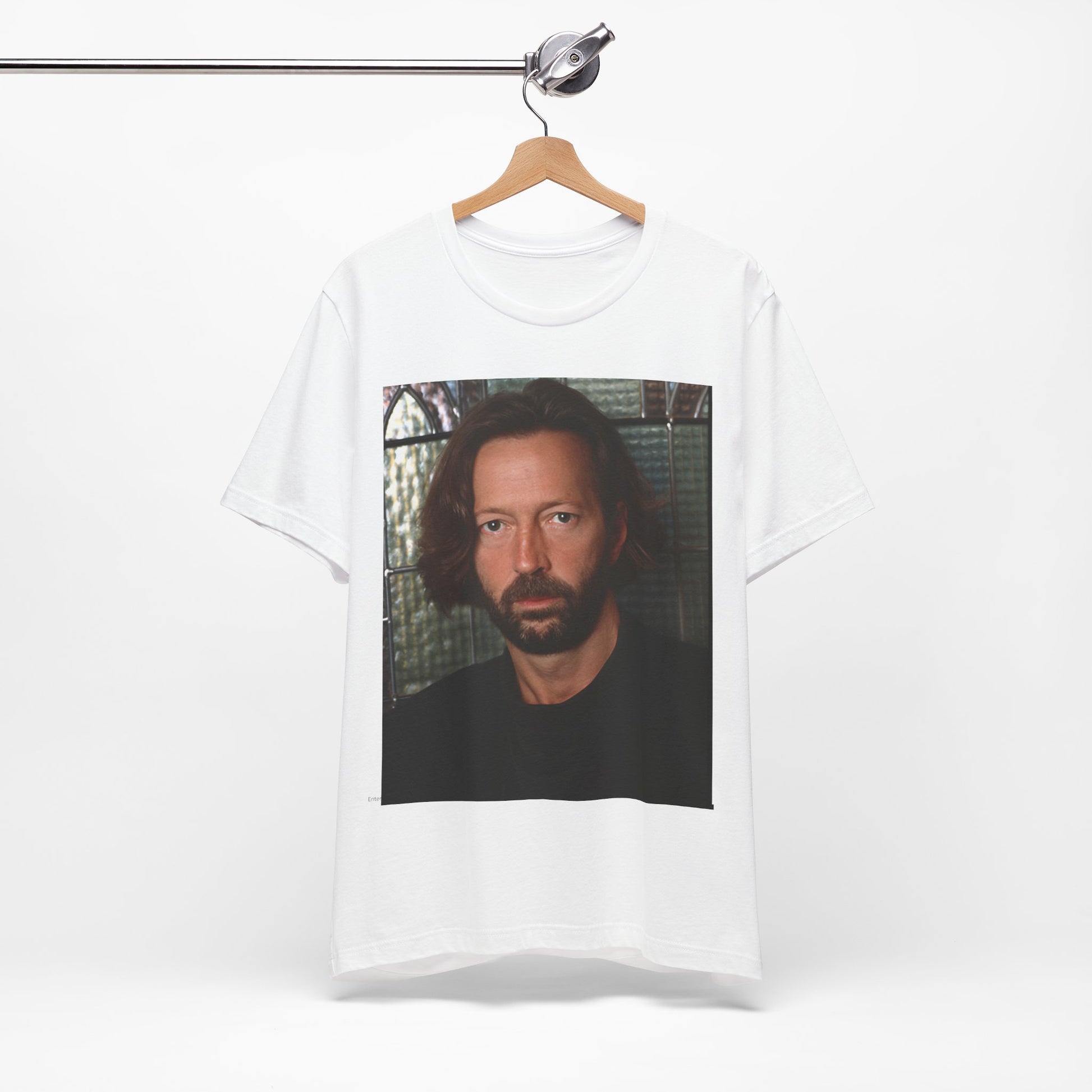 A black graphic t-shirt featuring a portrait graphic of Eric Clapton as a guitar god legend.