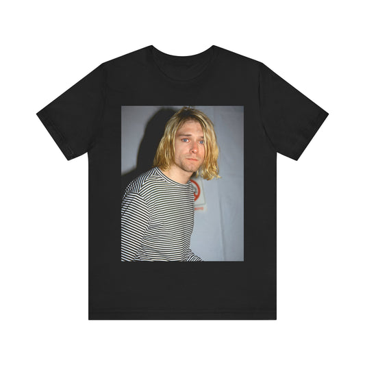 A black graphic t-shirt featuring a 90s photo portrait of Kurt Cobain from Nirvana.