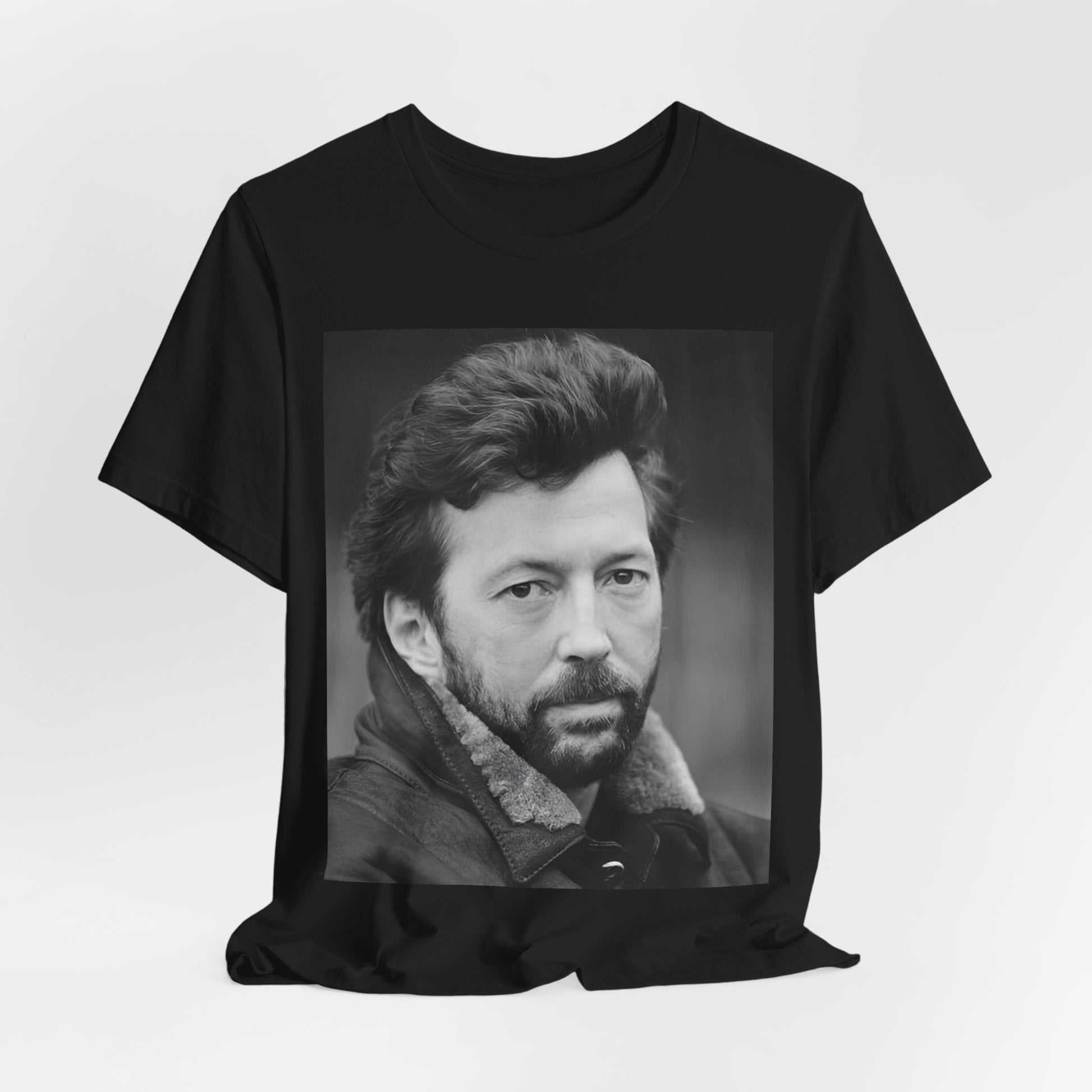 A black graphic t-shirt featuring a 70s rock aesthetic graphic of Eric Clapton.