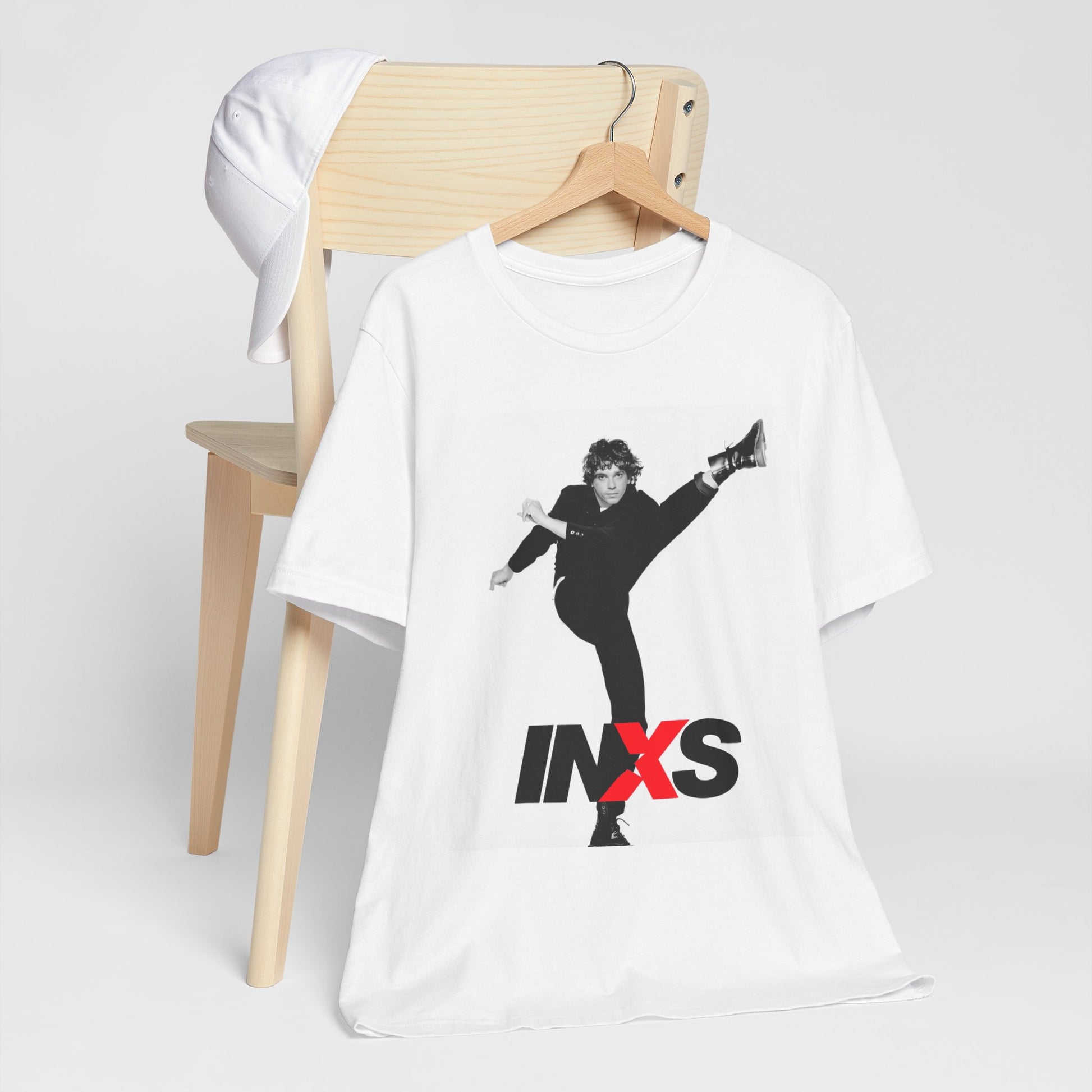 A black graphic t-shirt featuring a retro graphic related to INXS's 'Kick' album era.