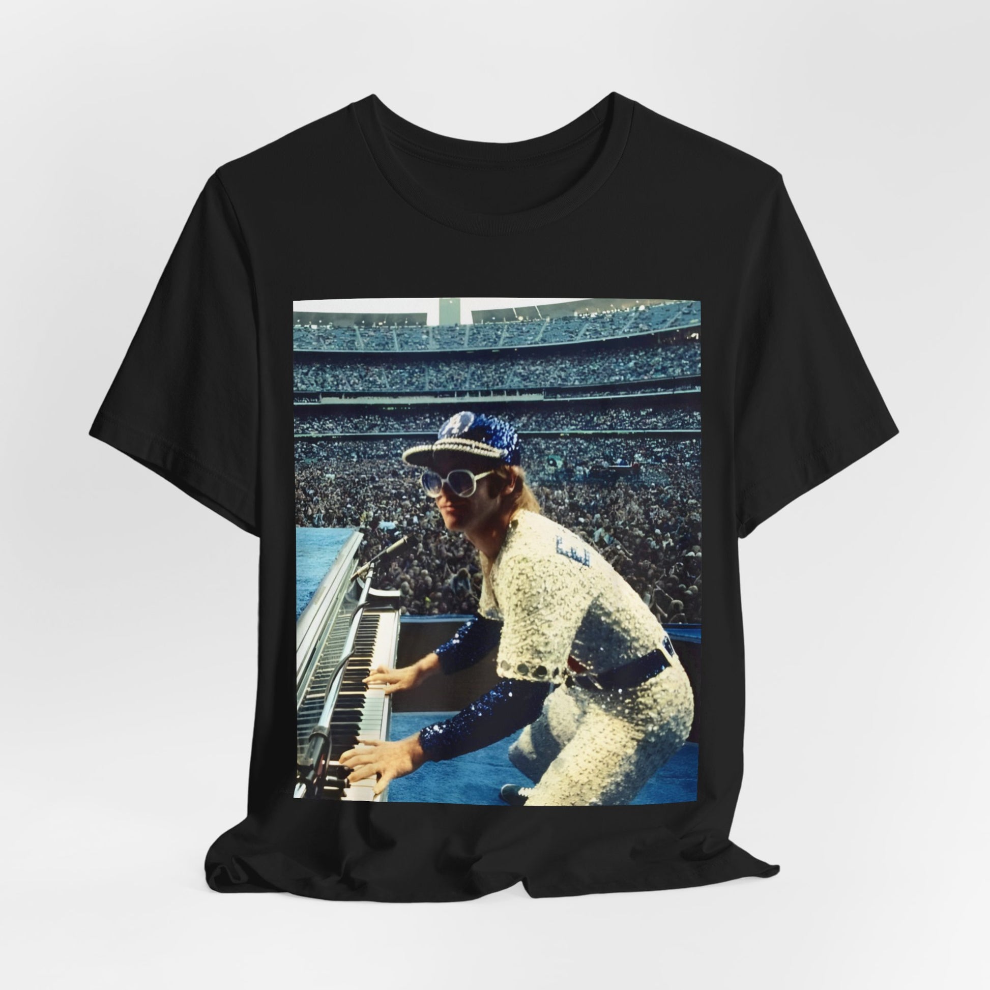 A black graphic t-shirt featuring a photo of Elton John from his 1975 Dodgers Stadium concert.