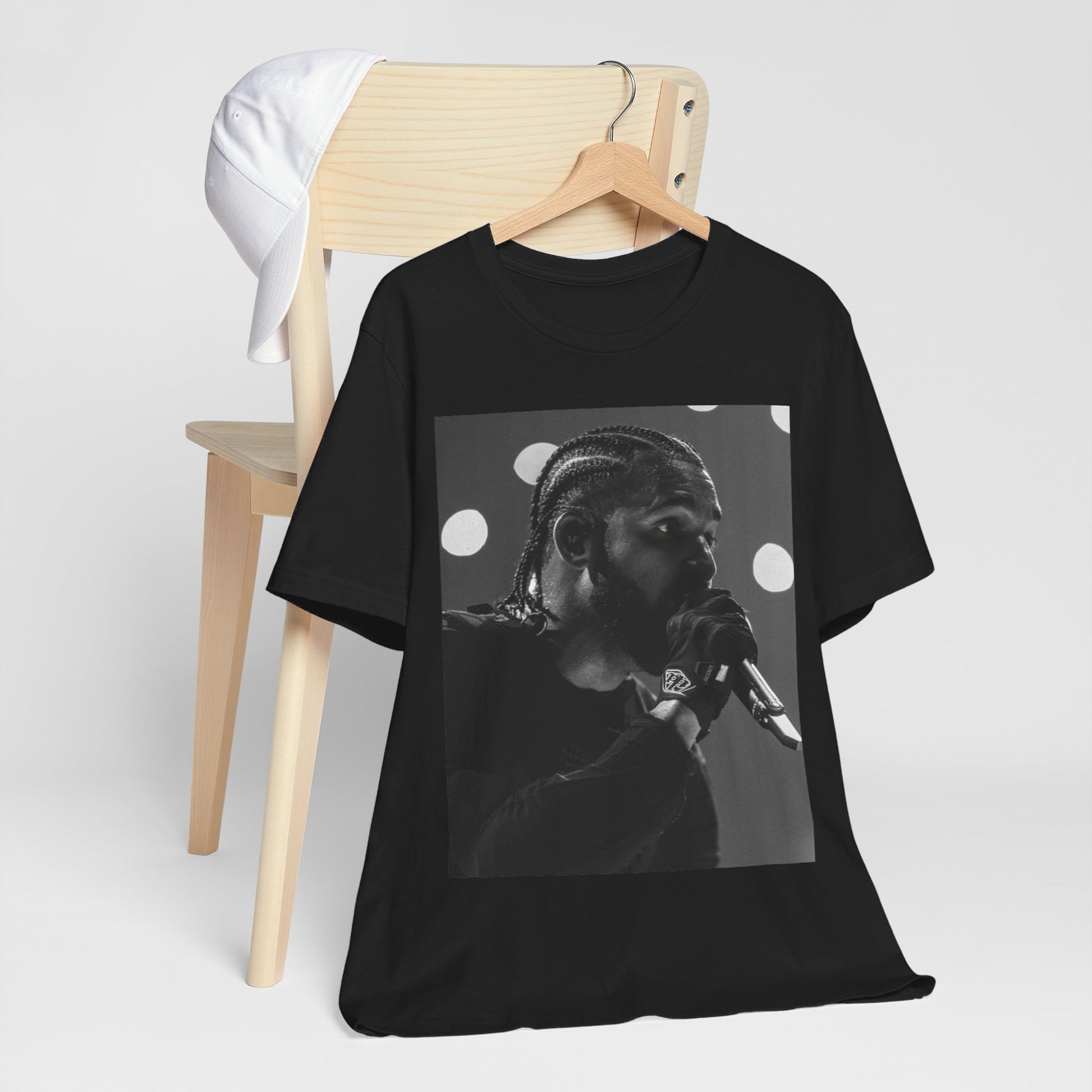 A black graphic t-shirt featuring a classic black and white style graphic of Drake.