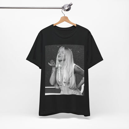 A black graphic t-shirt featuring a graphic of Karol G with a 'La Bichota Kiss' theme.