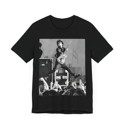 A black graphic t-shirt featuring a graphic of Billie Joe Armstrong from Green Day jumping on stage during a performance.
