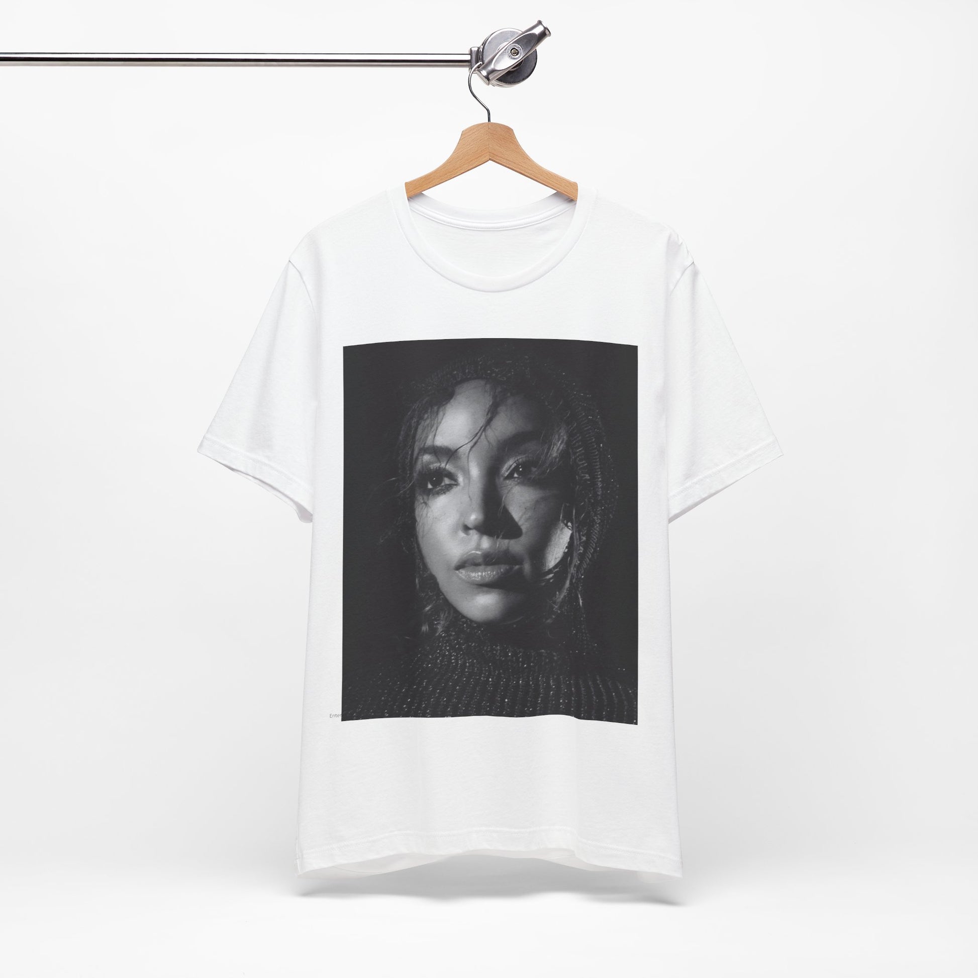 A black graphic t-shirt featuring a black and white portrait photo of Tinashe.