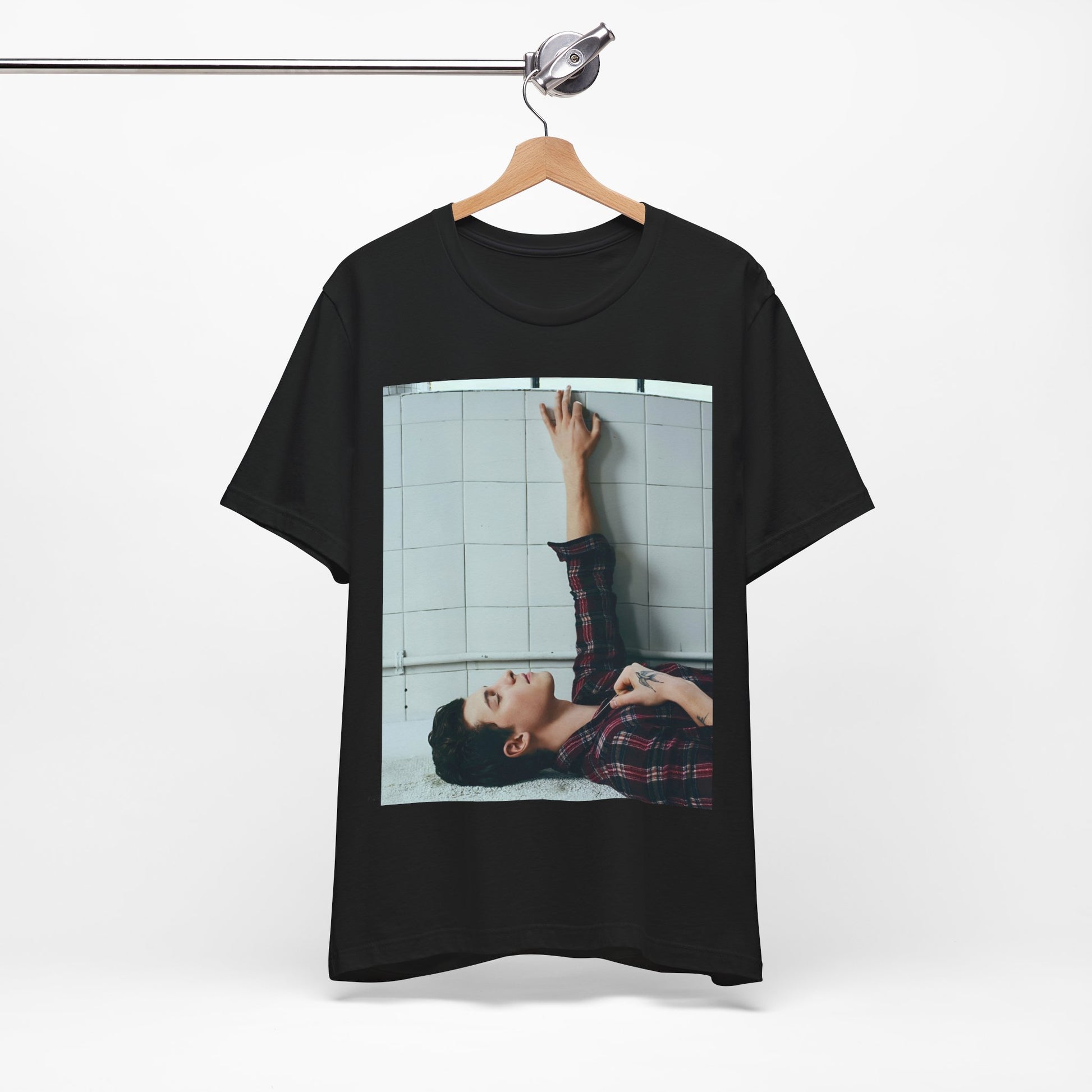 A black graphic t-shirt featuring a bold graphic of Shawn Mendes as a superstar.