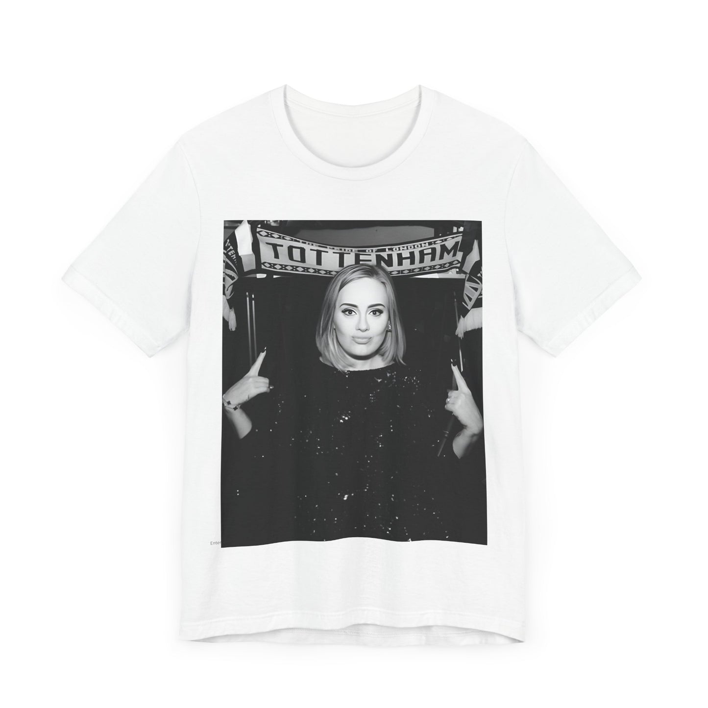 A black graphic t-shirt featuring a photo of Adele in a casual setting, surrounded by fans at a Tottenham event, showing her smiling or interacting.