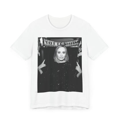 A black graphic t-shirt featuring a photo of Adele in a casual setting, surrounded by fans at a Tottenham event, showing her smiling or interacting.