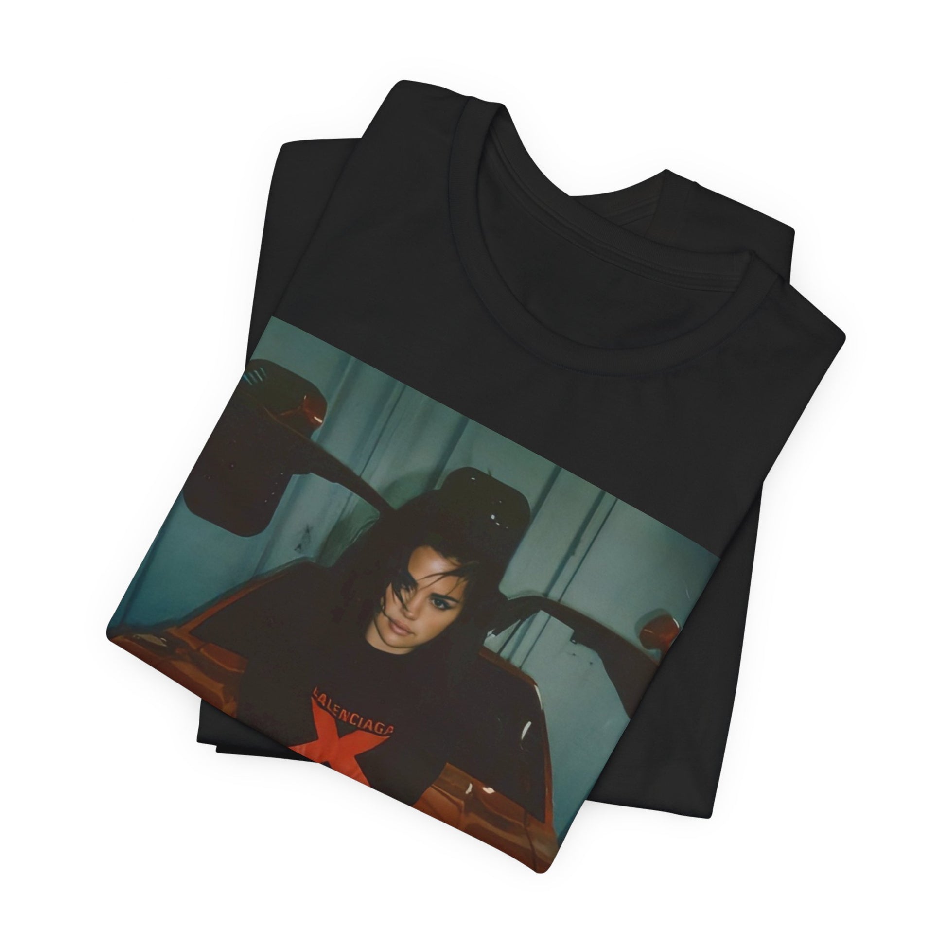A black graphic t-shirt featuring a photo or graphic of Selena Gomez with a car, designed with an 'X Rated' or edgy aesthetic.