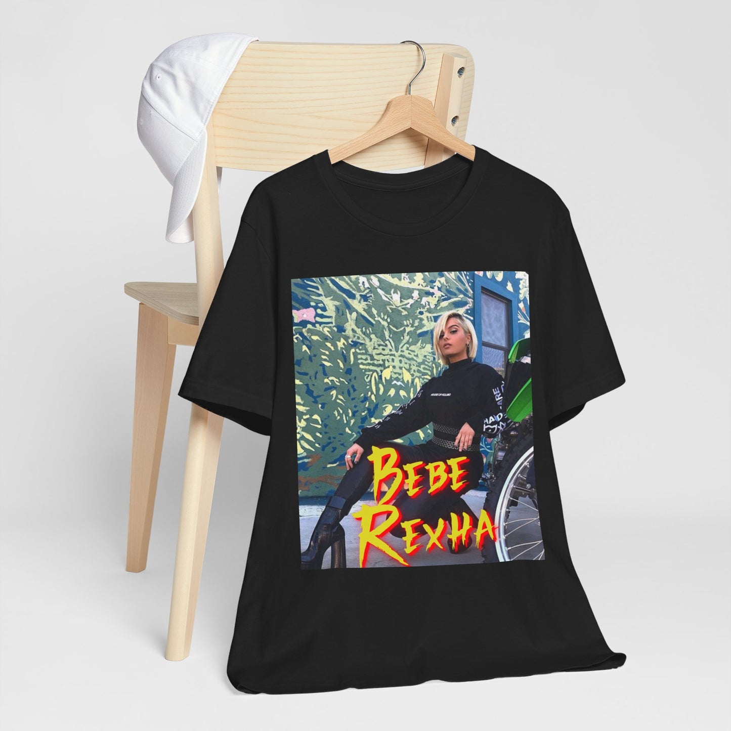 A black graphic t-shirt featuring a vintage pop aesthetic graphic of Bebe Rexha.