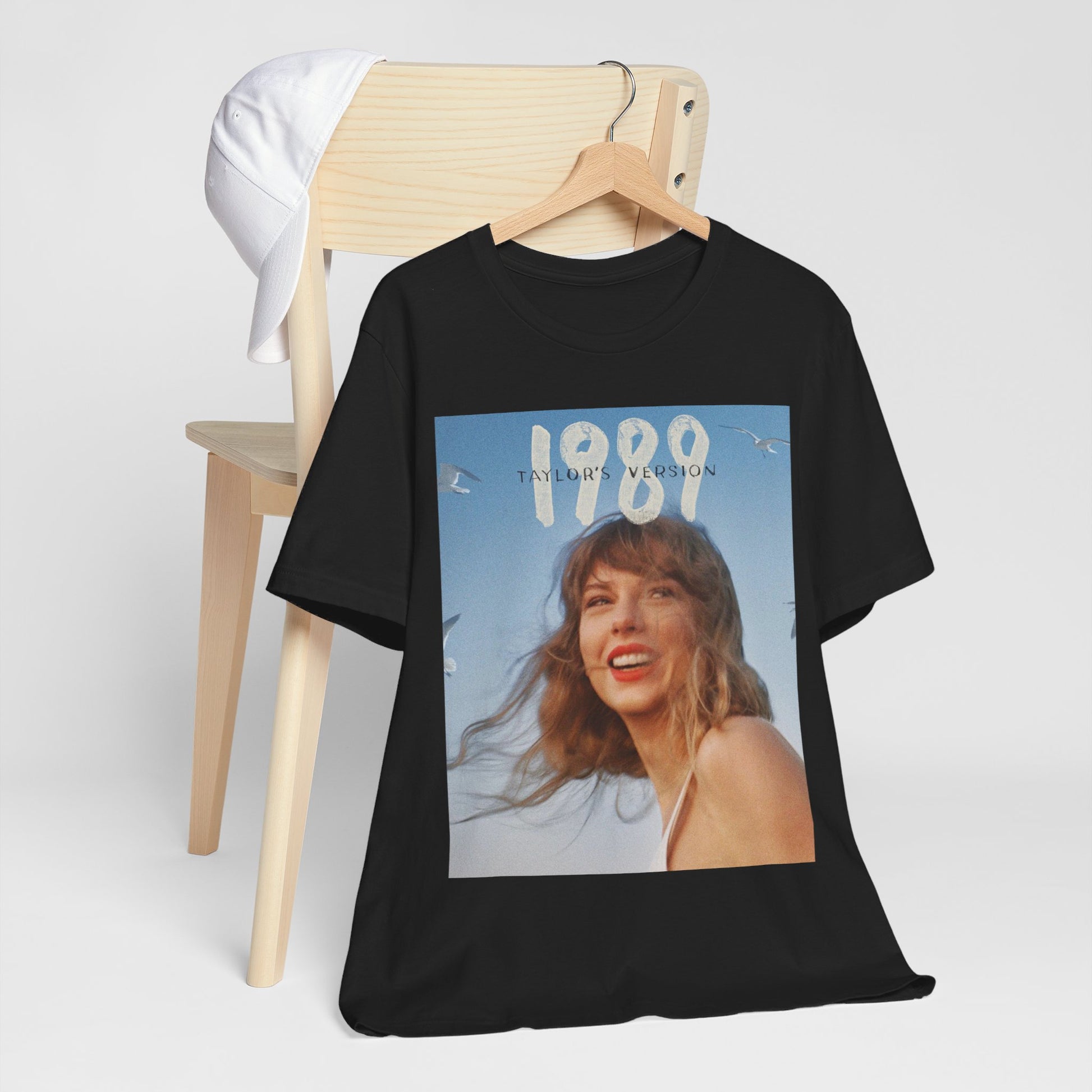 A black graphic t-shirt featuring a graphic related to Taylor Swift's 1989 album.
