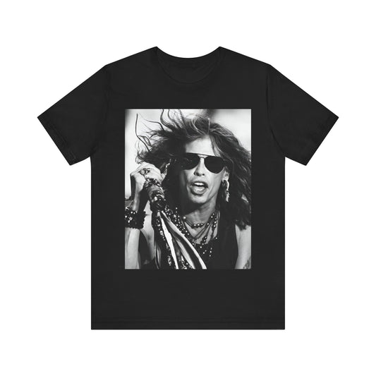 A black graphic t-shirt featuring a black and white photo of Aerosmith's Steven Tyler with his signature scarf and microphone, captured during a dynamic performance.