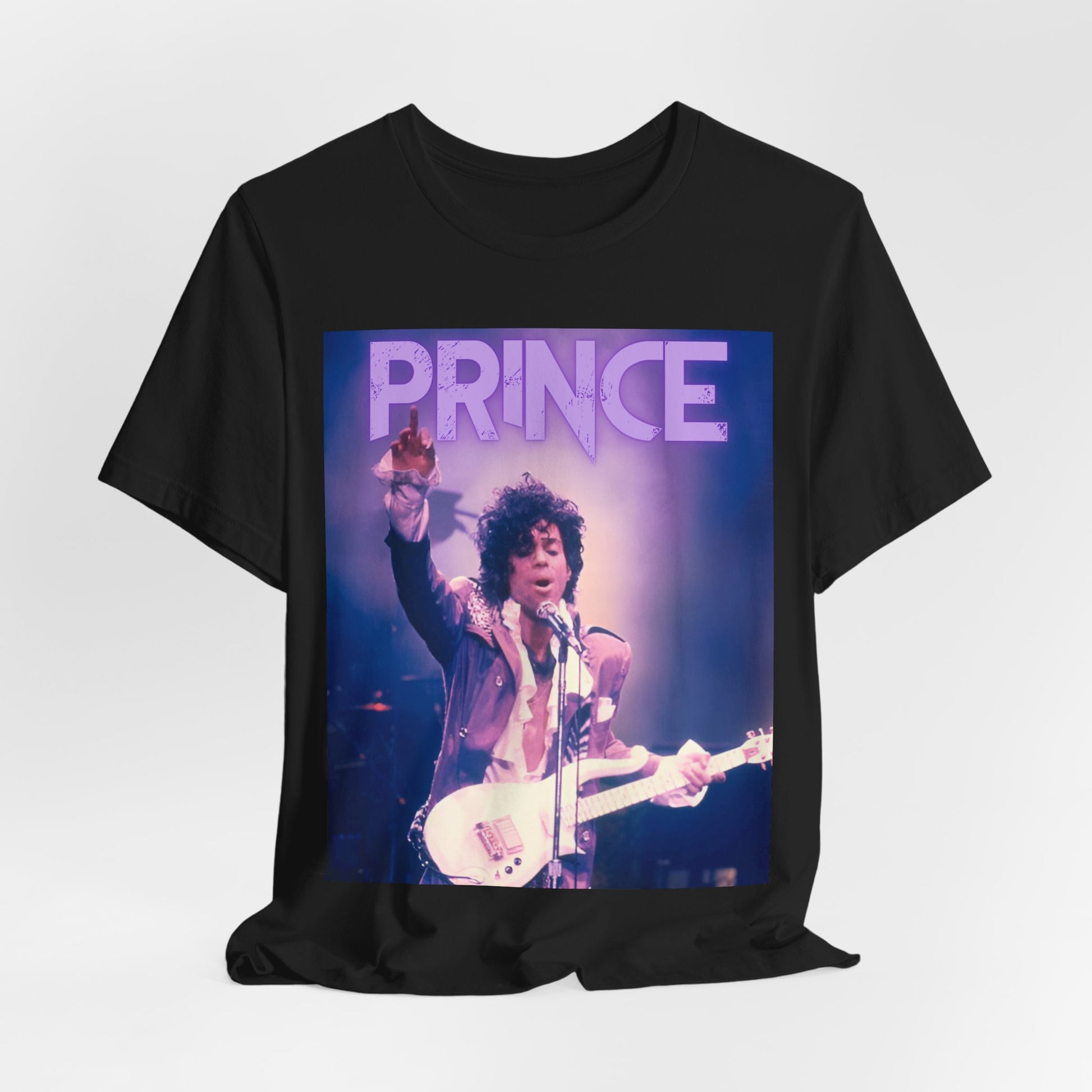A black graphic t-shirt featuring a retro graphic related to Prince's 'Purple Rain' album era.