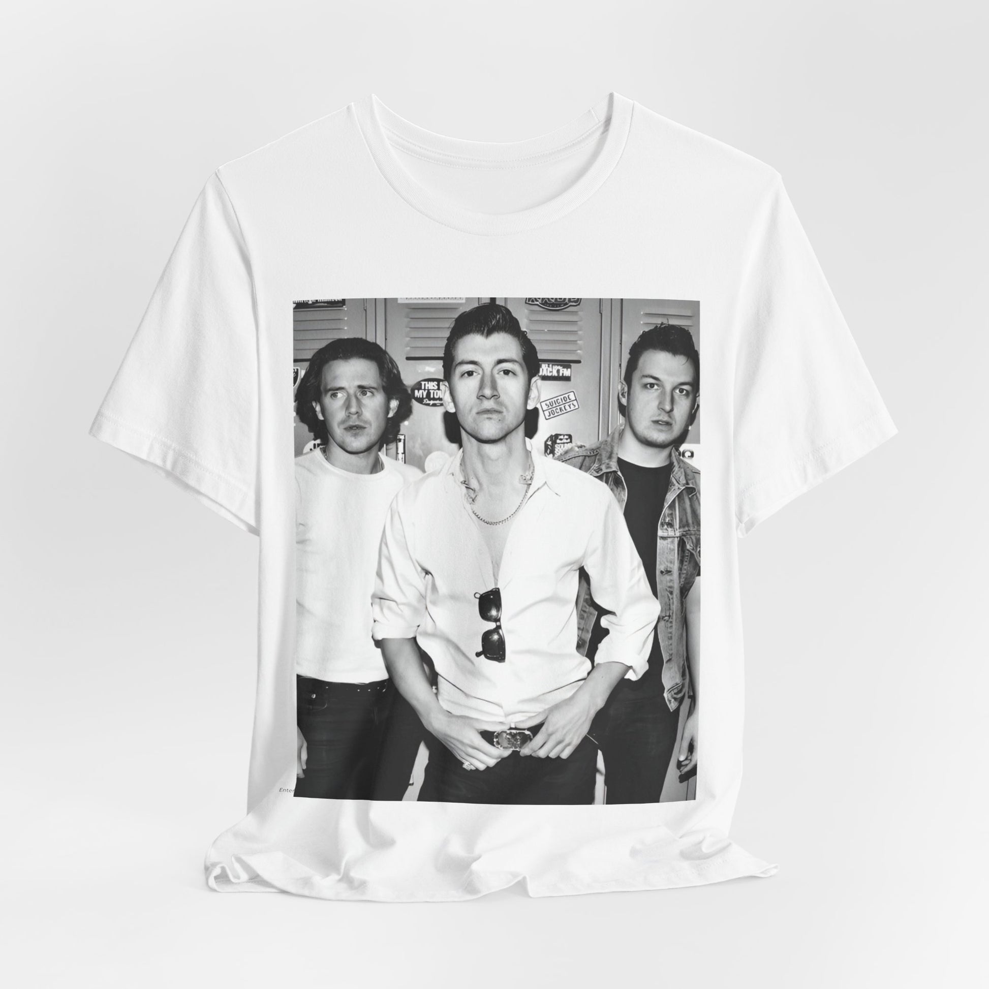 A black graphic t-shirt featuring a vintage-style design related to Arctic Monkeys' 'AM' album era, possibly with the album art or band imagery.