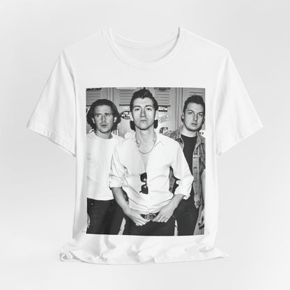 A black graphic t-shirt featuring a vintage-style design related to Arctic Monkeys' 'AM' album era, possibly with the album art or band imagery.