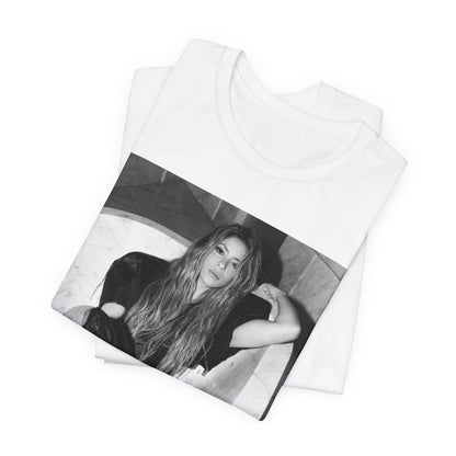 A black graphic t-shirt featuring a retro graphic related to Shakira's 'Hips Don't Lie' song or era.