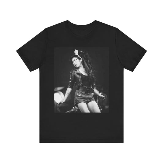 A black graphic t-shirt featuring a graphic related to Amy Winehouse's 'Frank' album era from 2003, possibly with early portrait imagery.
