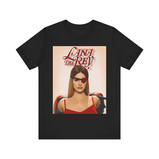 Lana Del Rey posing as a femme fatale with a red, heart-shaped eyepatch, printed on a graphic t-shirt.