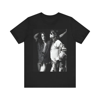 A black graphic t-shirt featuring a dynamic photo or illustration of Aerosmith's Steven Tyler and Joe Perry performing together on stage, highlighting their synergy.