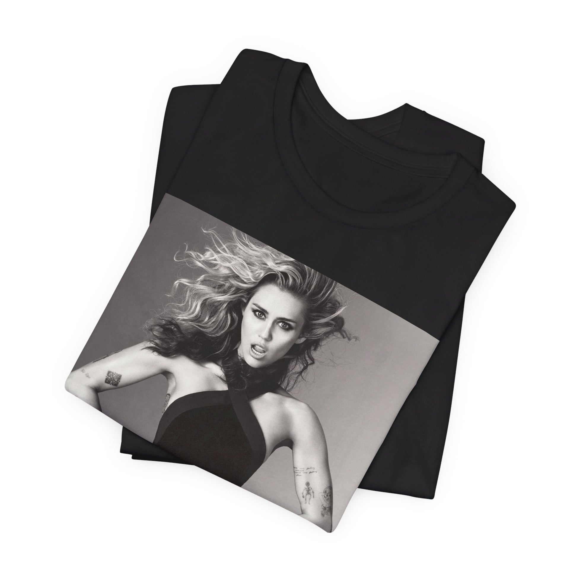 A black graphic t-shirt featuring a bold graphic of Miley Cyrus as a pop superstar.