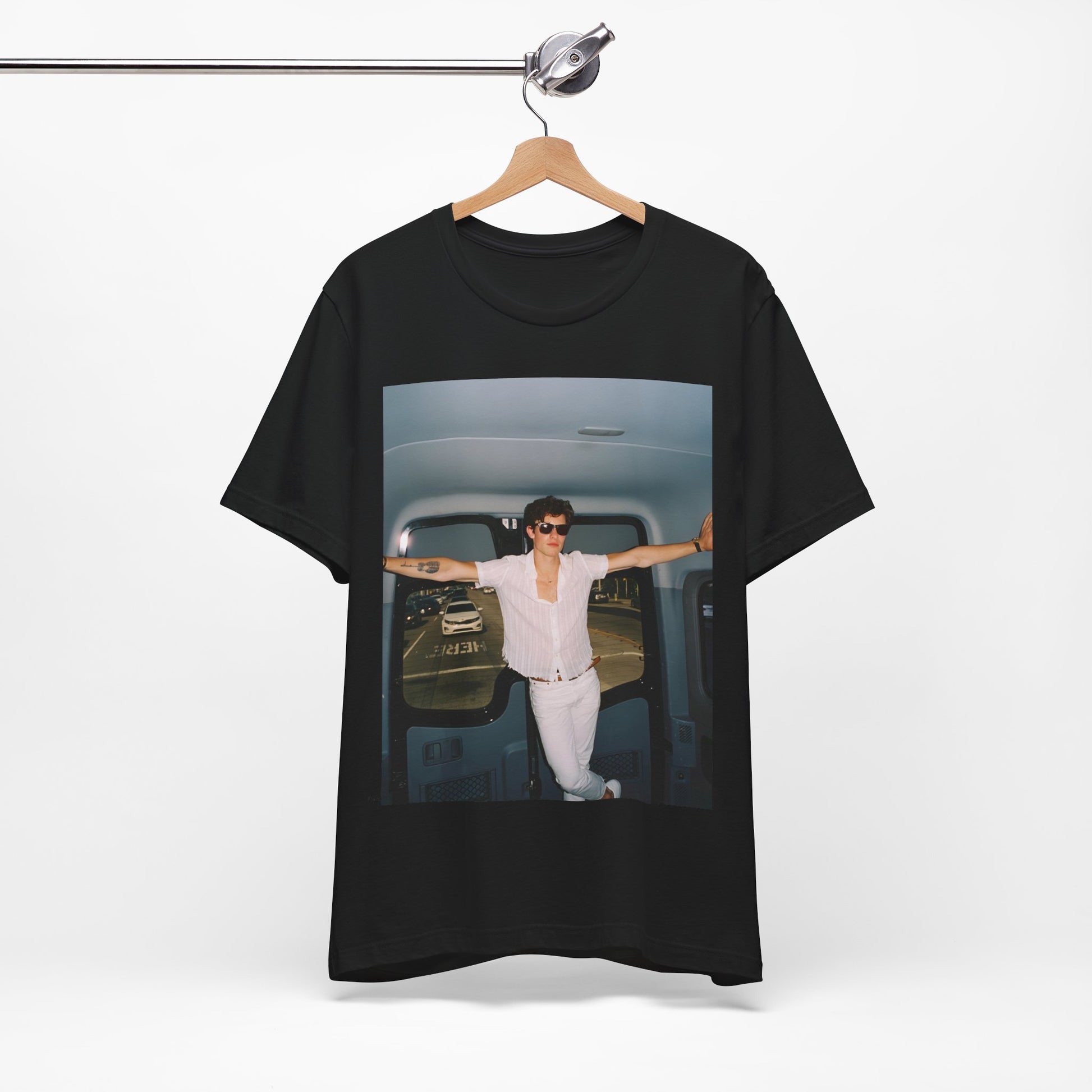 A black graphic t-shirt featuring a graphic of Shawn Mendes with a classic confident look.