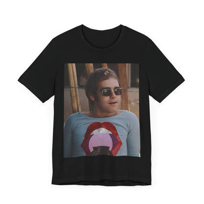 A black graphic t-shirt featuring a classic graphic related to Elton John's 'Tiny Dancer' song or era.