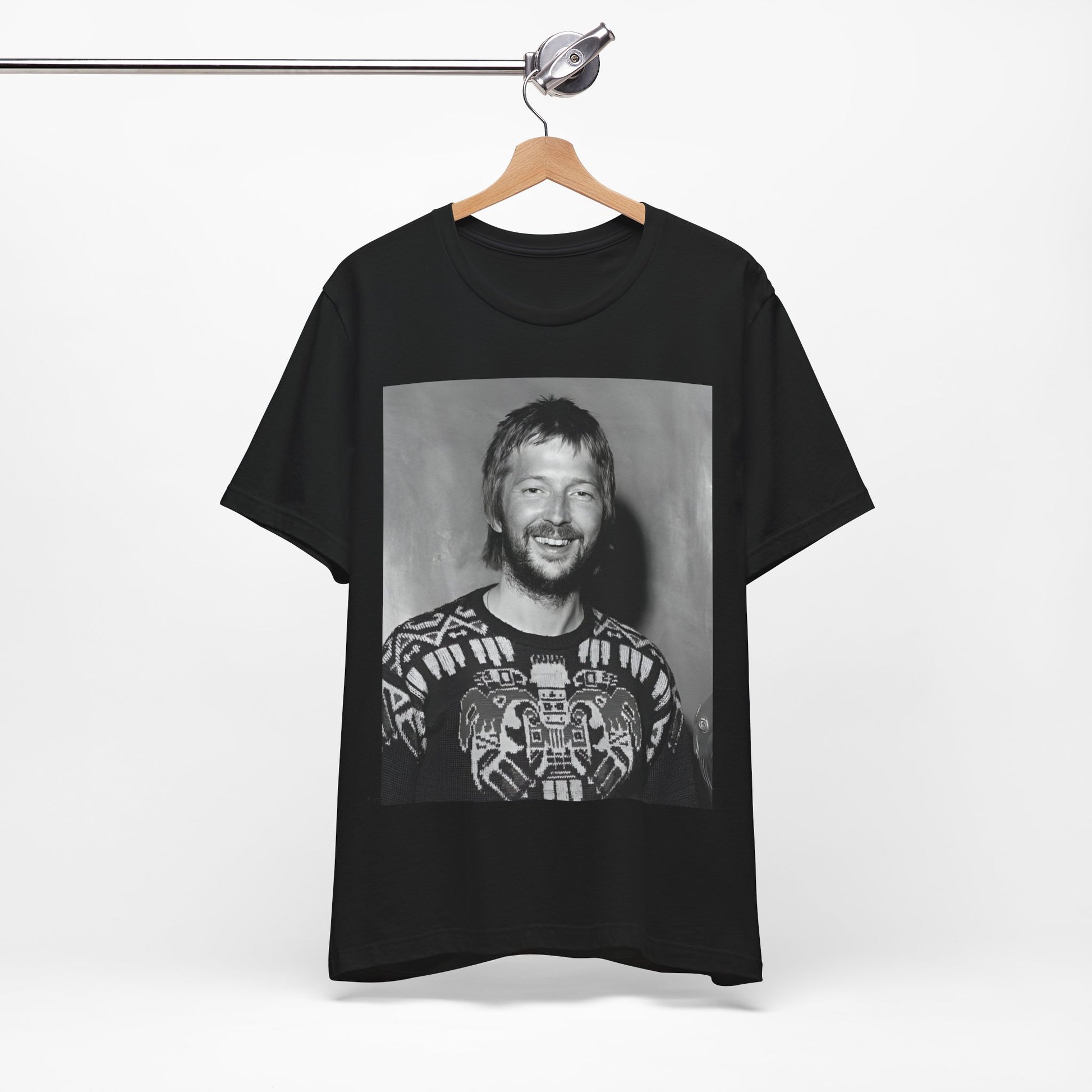 A black graphic t-shirt featuring a 70s photo portrait of Eric Clapton.