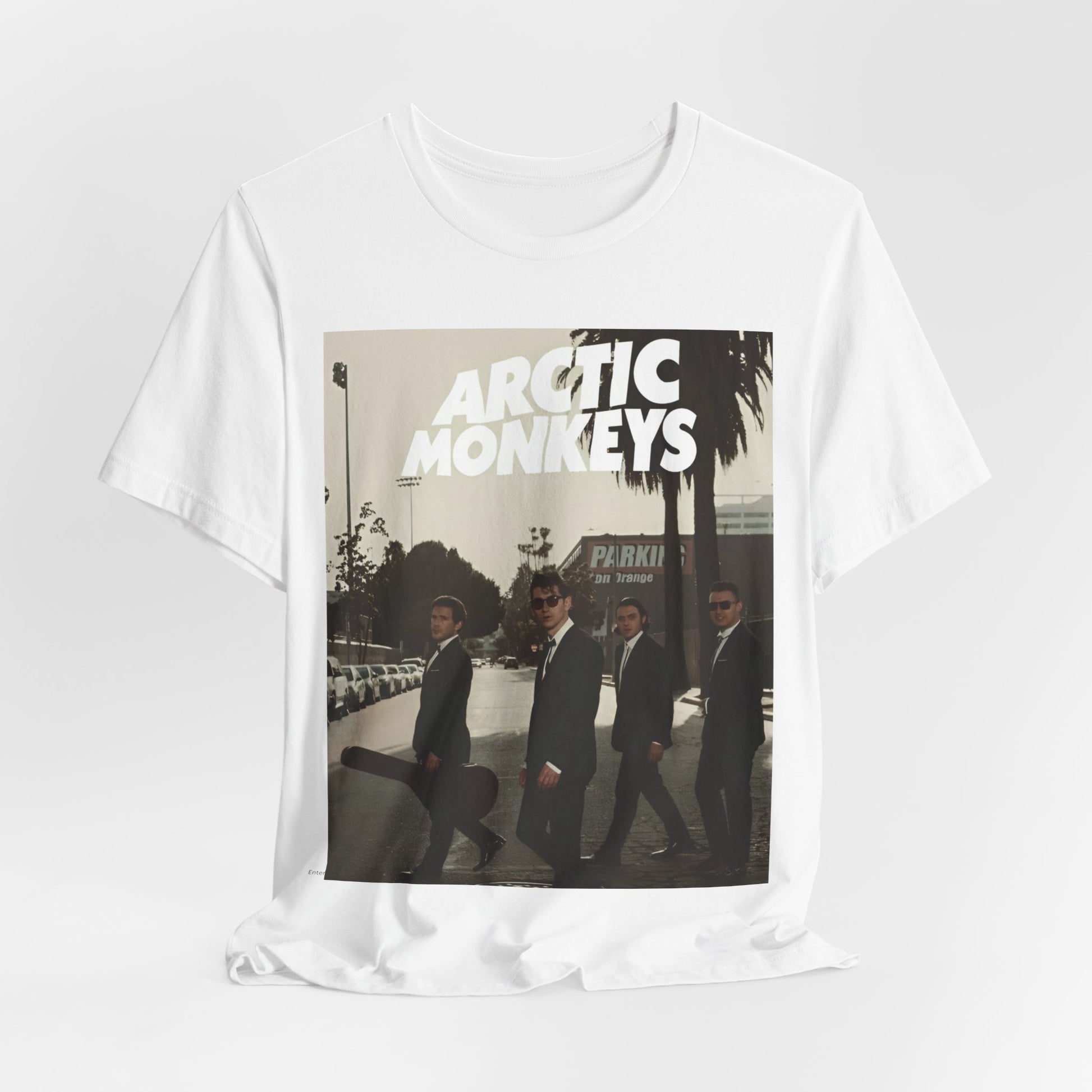 A black graphic t-shirt featuring Arctic Monkeys in a pose or setting similar to the iconic 'Abbey Road' album cover.