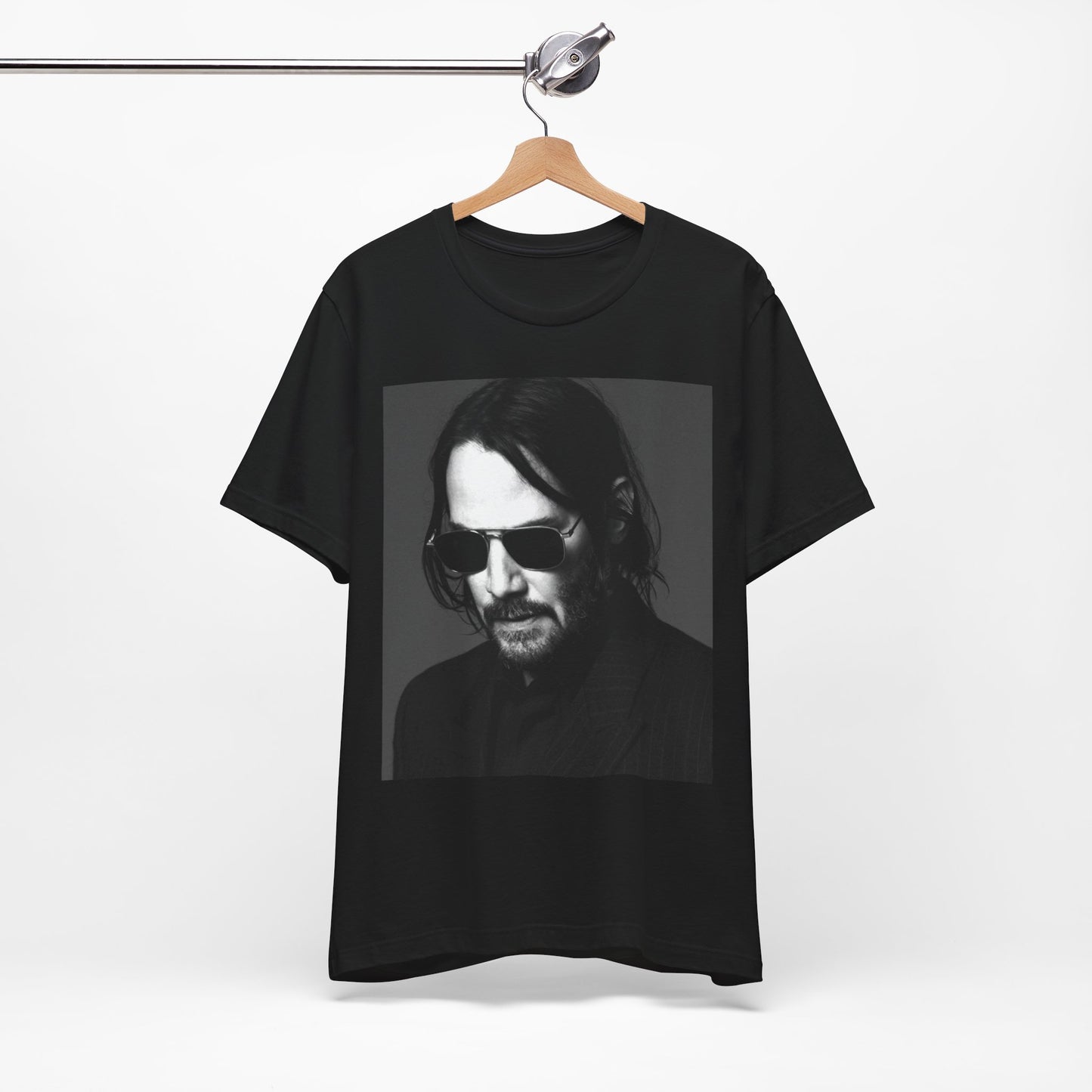 A black graphic t-shirt featuring a graphic of Keanu Reeves with a rebel spirit aesthetic.