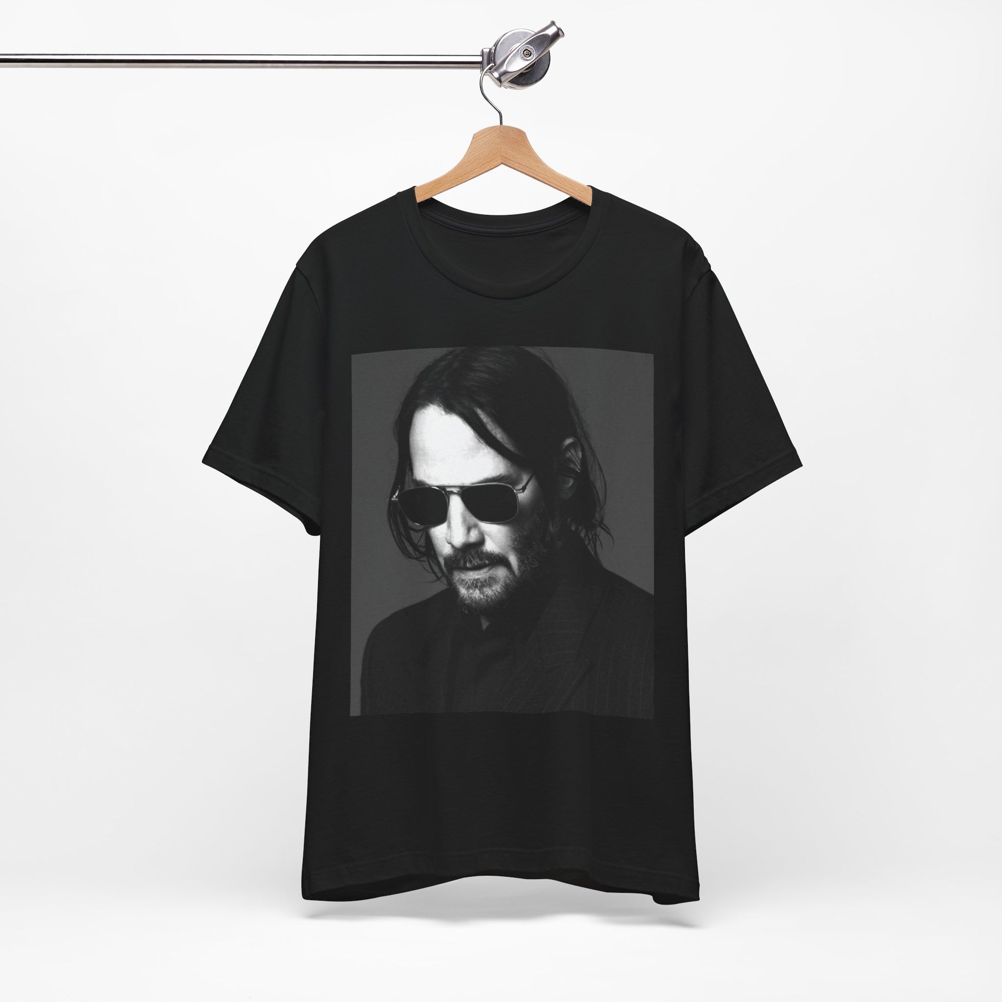 A black graphic t-shirt featuring a graphic of Keanu Reeves with a rebel spirit aesthetic.