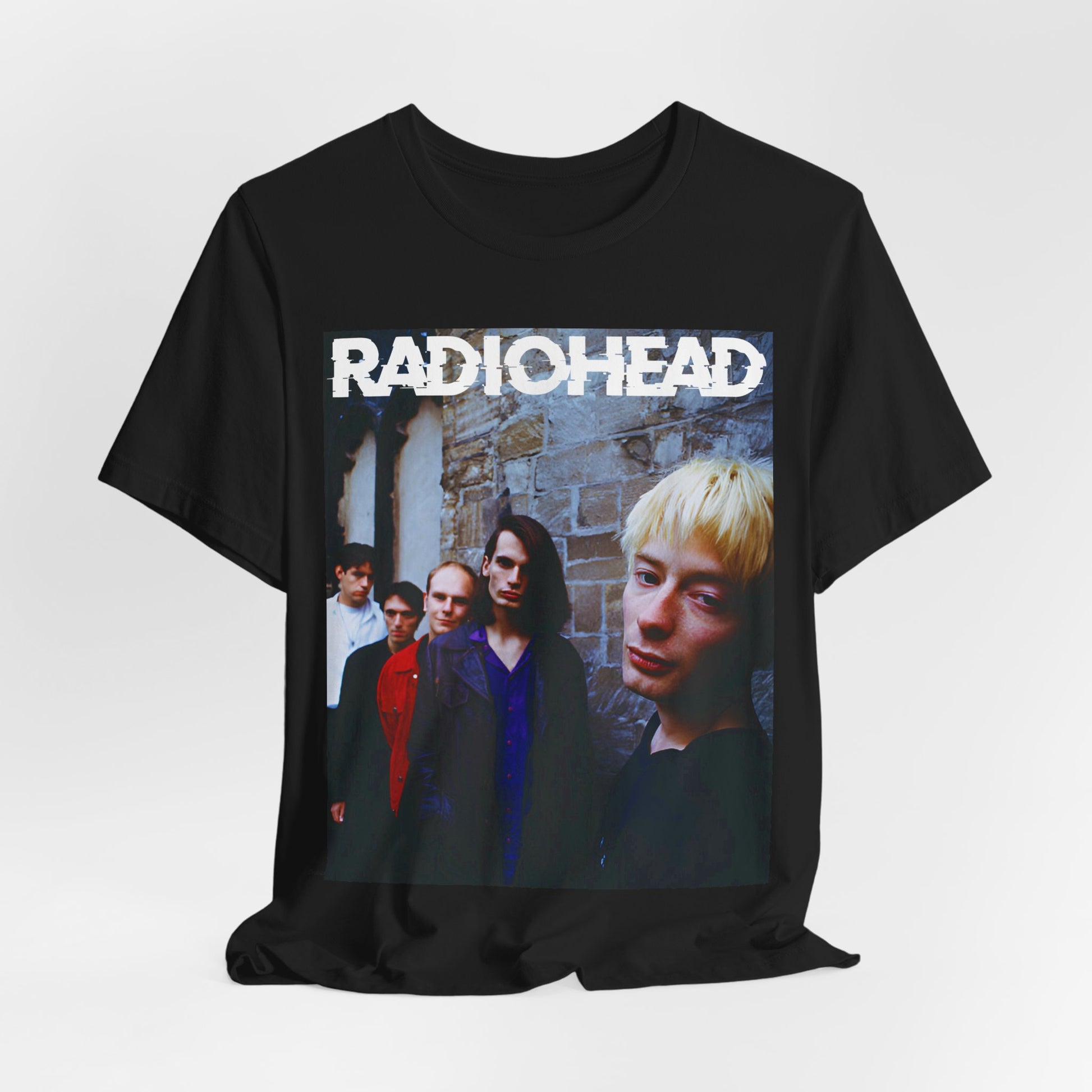 A black graphic t-shirt featuring a 90s graphic related to Radiohead's 'Karma Police' song or era.
