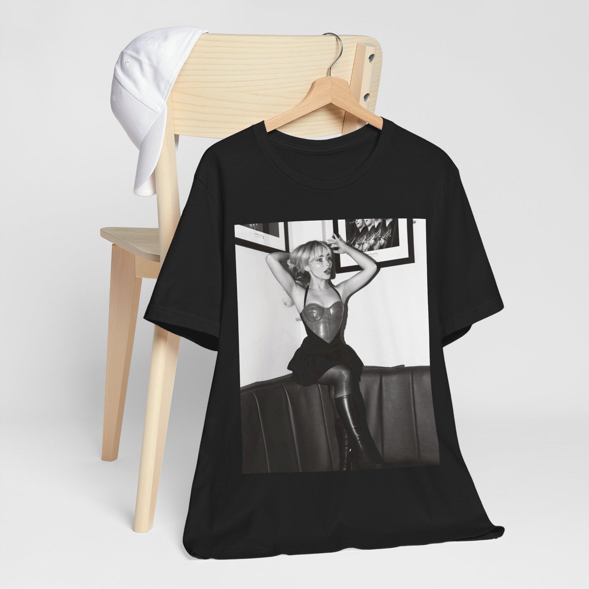A black graphic t-shirt featuring a black and white graphic of Sabrina Carpenter as a pop princess.