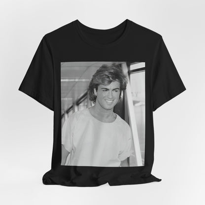 A black graphic t-shirt featuring an 80s black and white vintage photo or graphic of George Michael.