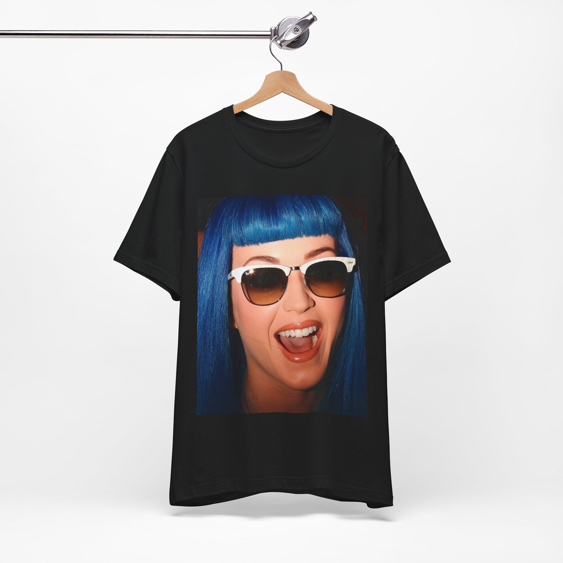 A black graphic t-shirt featuring a retro graphic of Katy Perry with blue hair.