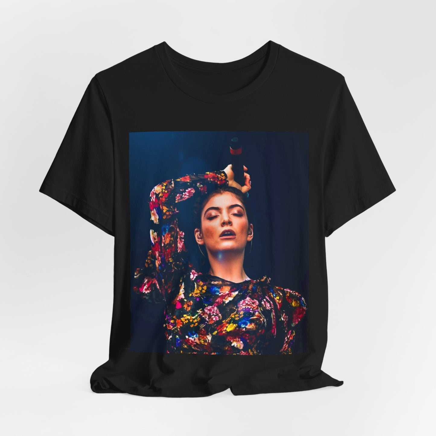 A black graphic t-shirt featuring a retro graphic related to Lorde's 'Pure Heroine' album era.