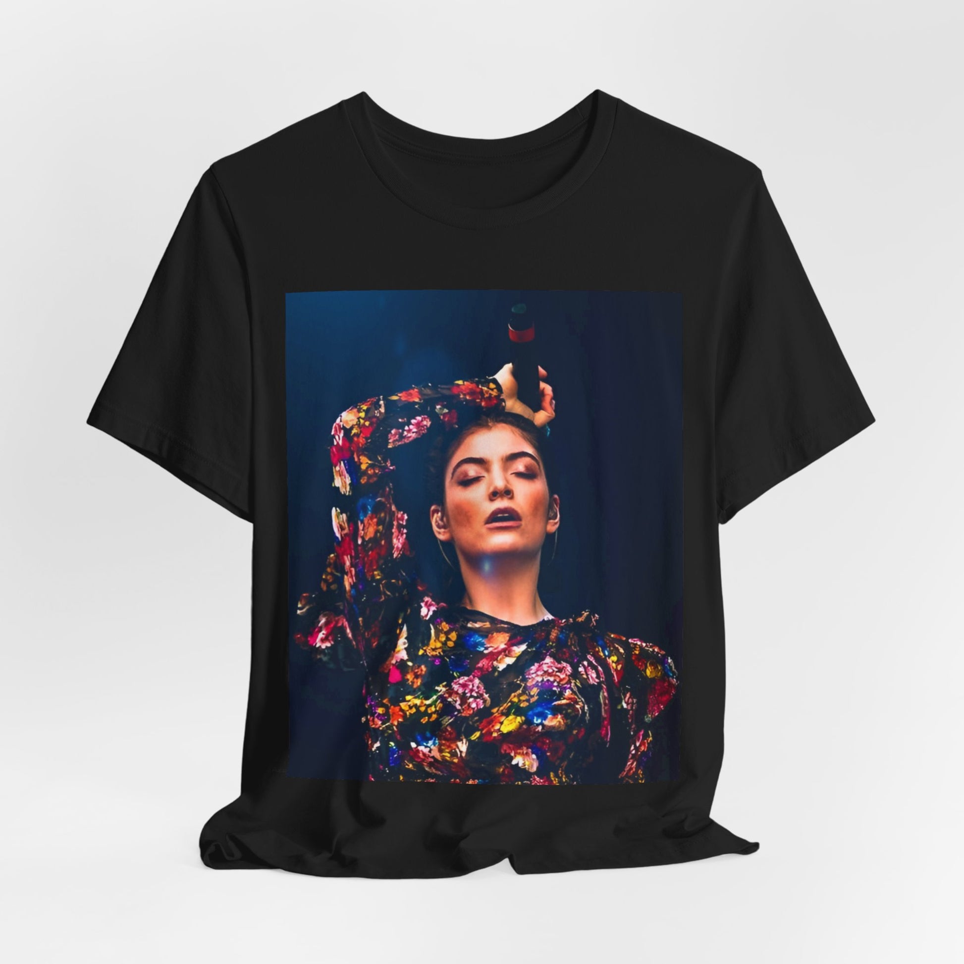 A black graphic t-shirt featuring a retro graphic related to Lorde's 'Pure Heroine' album era.