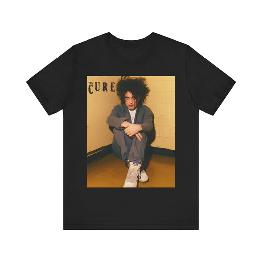 A black graphic t-shirt featuring a bold goth rock superstar graphic of The Cure.