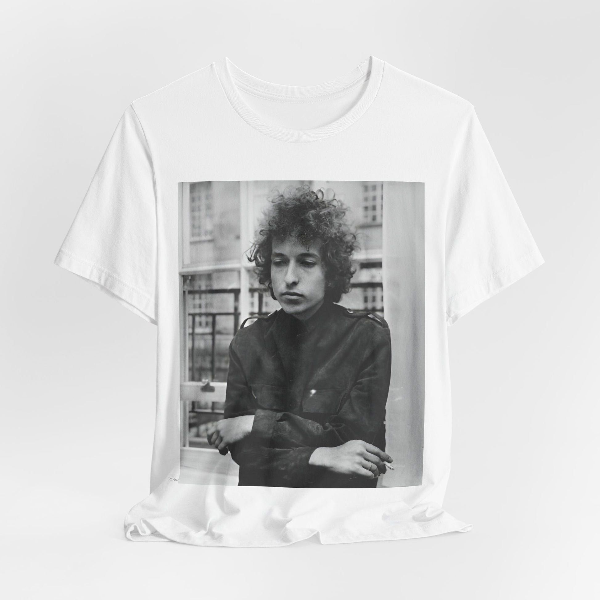 A black graphic t-shirt featuring a black and white graphic of Bob Dylan from the folk revival era.