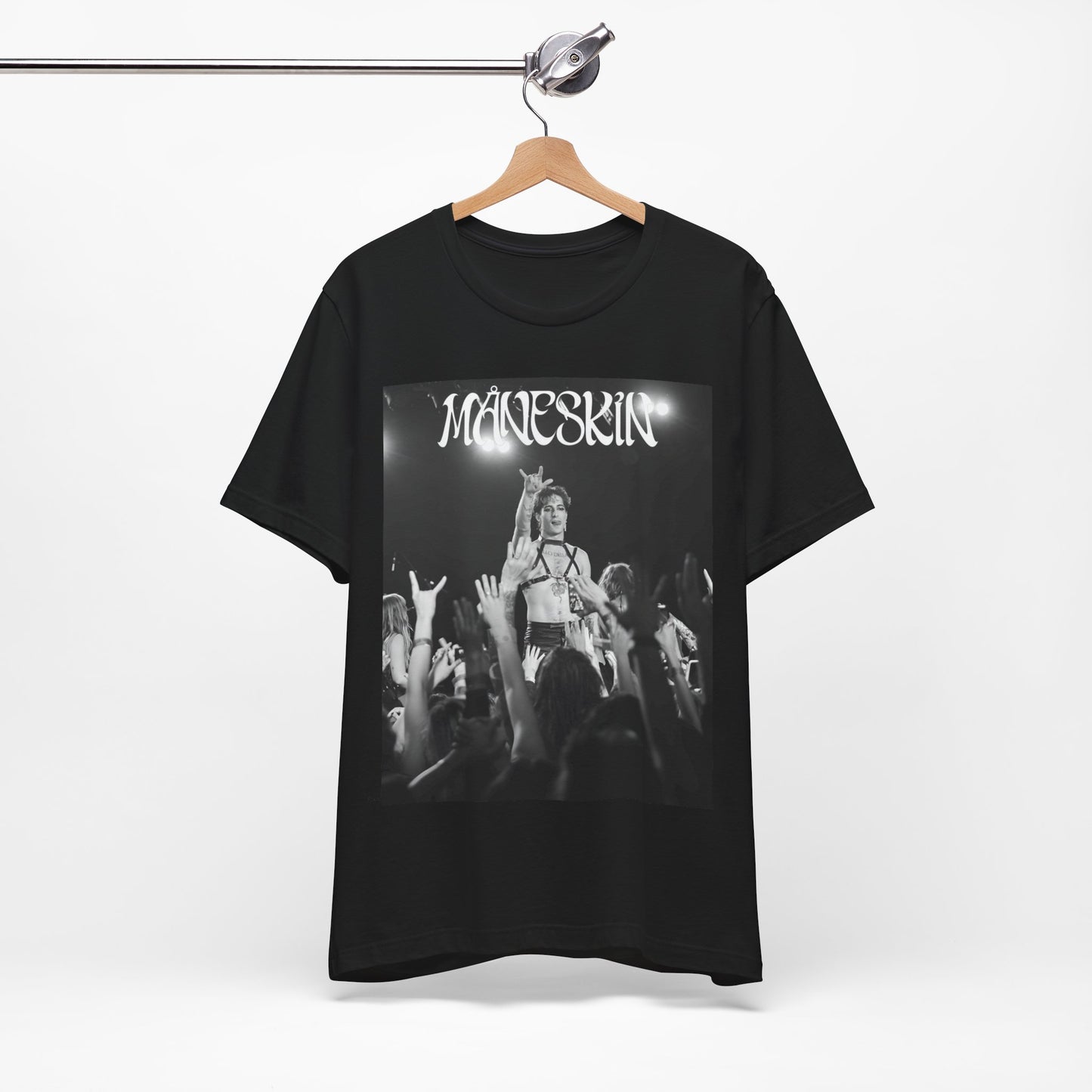 A black graphic t-shirt featuring a graphic or photo of Maneskin performing live.