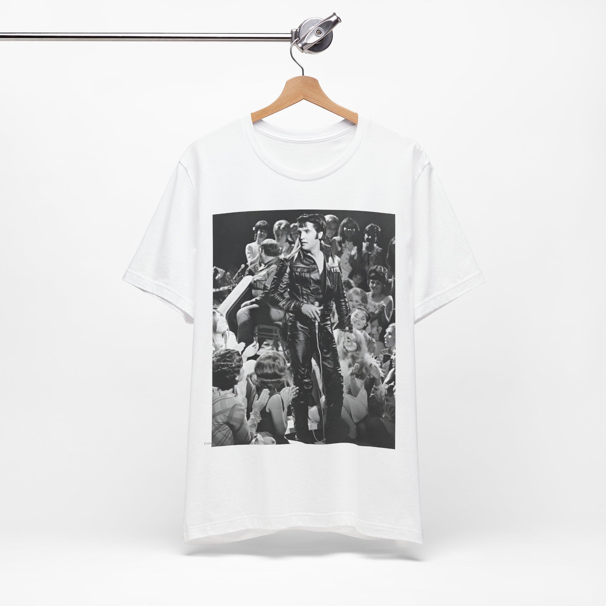 A black graphic t-shirt featuring a vintage black and white photo or graphic of Elvis Presley performing live on stage.