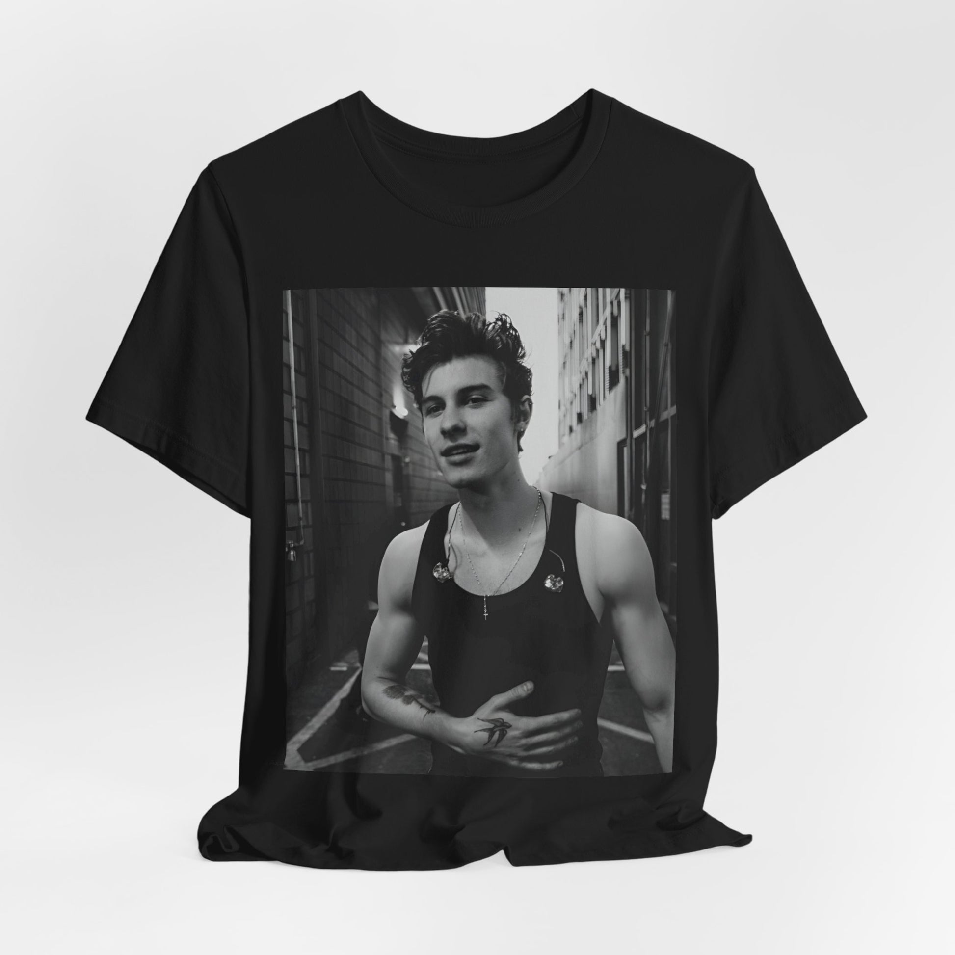 A black graphic t-shirt featuring a vintage black and white portrait graphic or photo of Shawn Mendes.