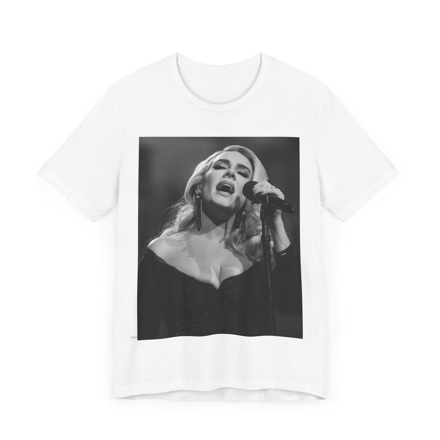 A black graphic t-shirt featuring a dynamic image of Adele performing on stage, with lighting effects, likely from her 'One Night Only' concert special.