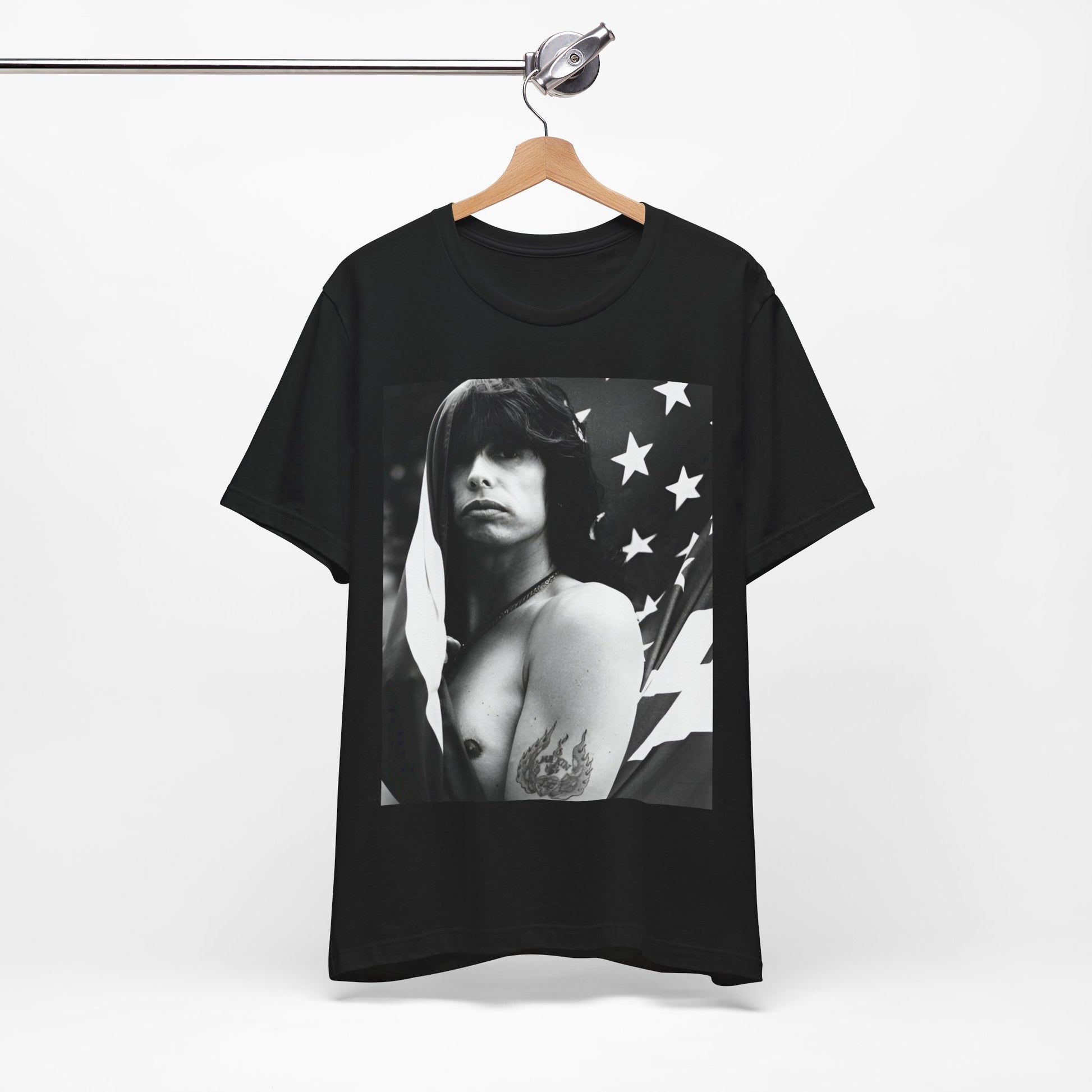 A black graphic t-shirt featuring a retro 70s-style illustration or photo of Aerosmith, integrated with elements of the American flag.
