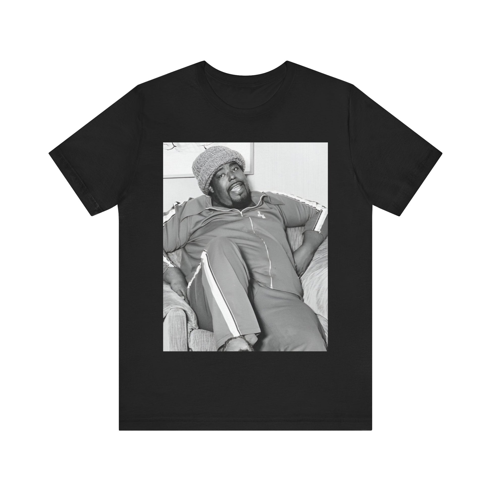 A black graphic t-shirt featuring a 70s-style portrait photo of Barry White in a lounge setting.