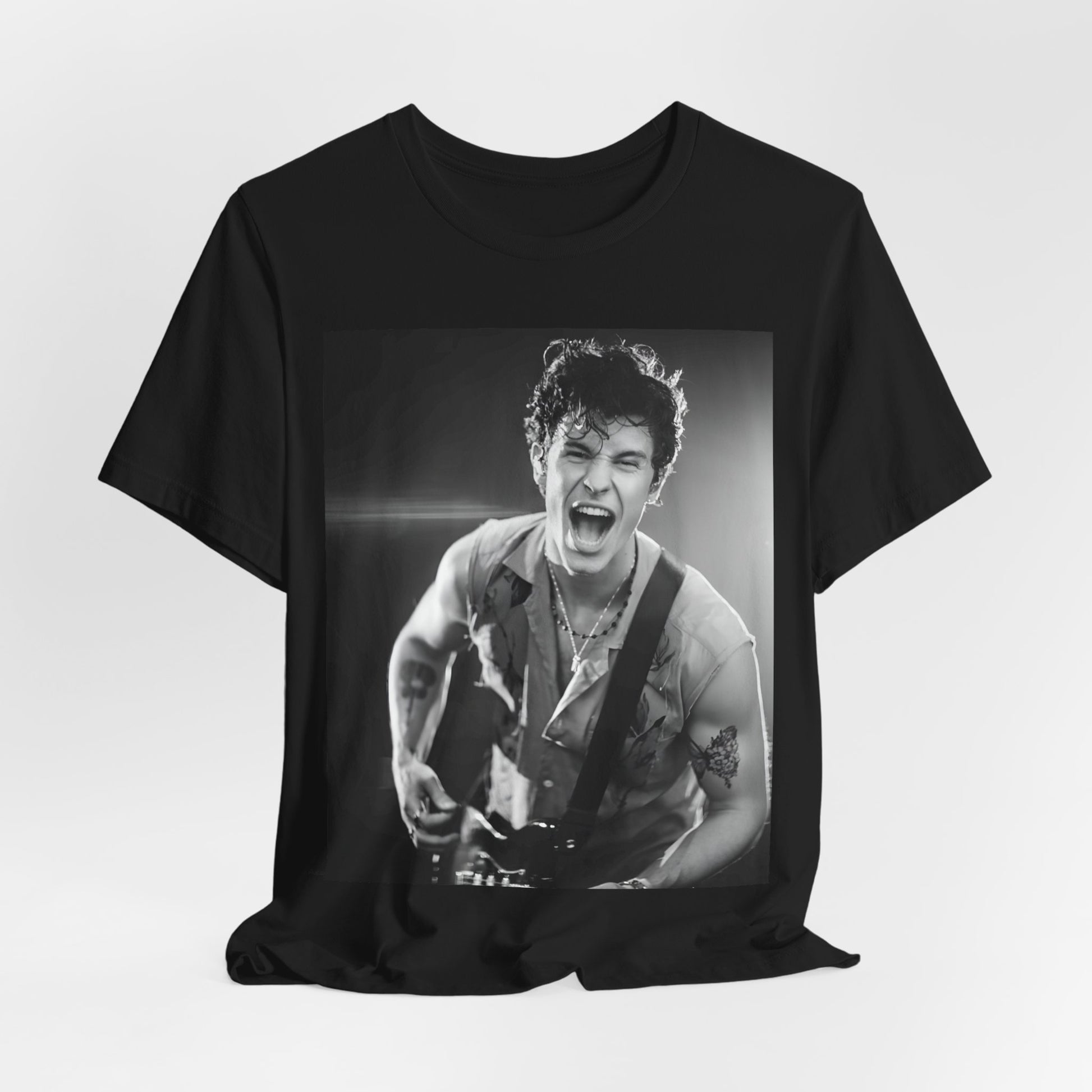 A black graphic t-shirt featuring a black and white photo of Shawn Mendes, emphasizing his charm.