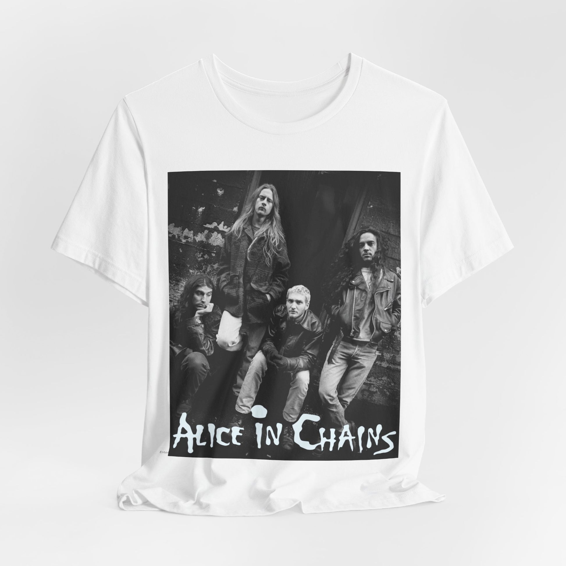 A black graphic t-shirt featuring a 90s black and white photographic portrait of the band Alice In Chains, capturing their iconic grunge look.